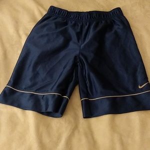 A pair of blue shorts for a 5 year old boy. The shirts are made by Nike